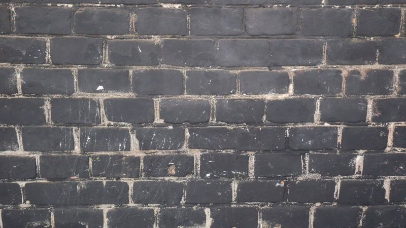 Remove soot from brick.